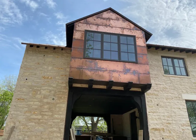 Copper metal panel facade on a stone building for Metal Roof Coating in Sumner